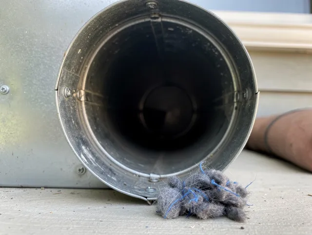 New Franklin Dryer Vent Cleaning technician using specialized equipment to clear severe dryer vent blockage in New Franklin